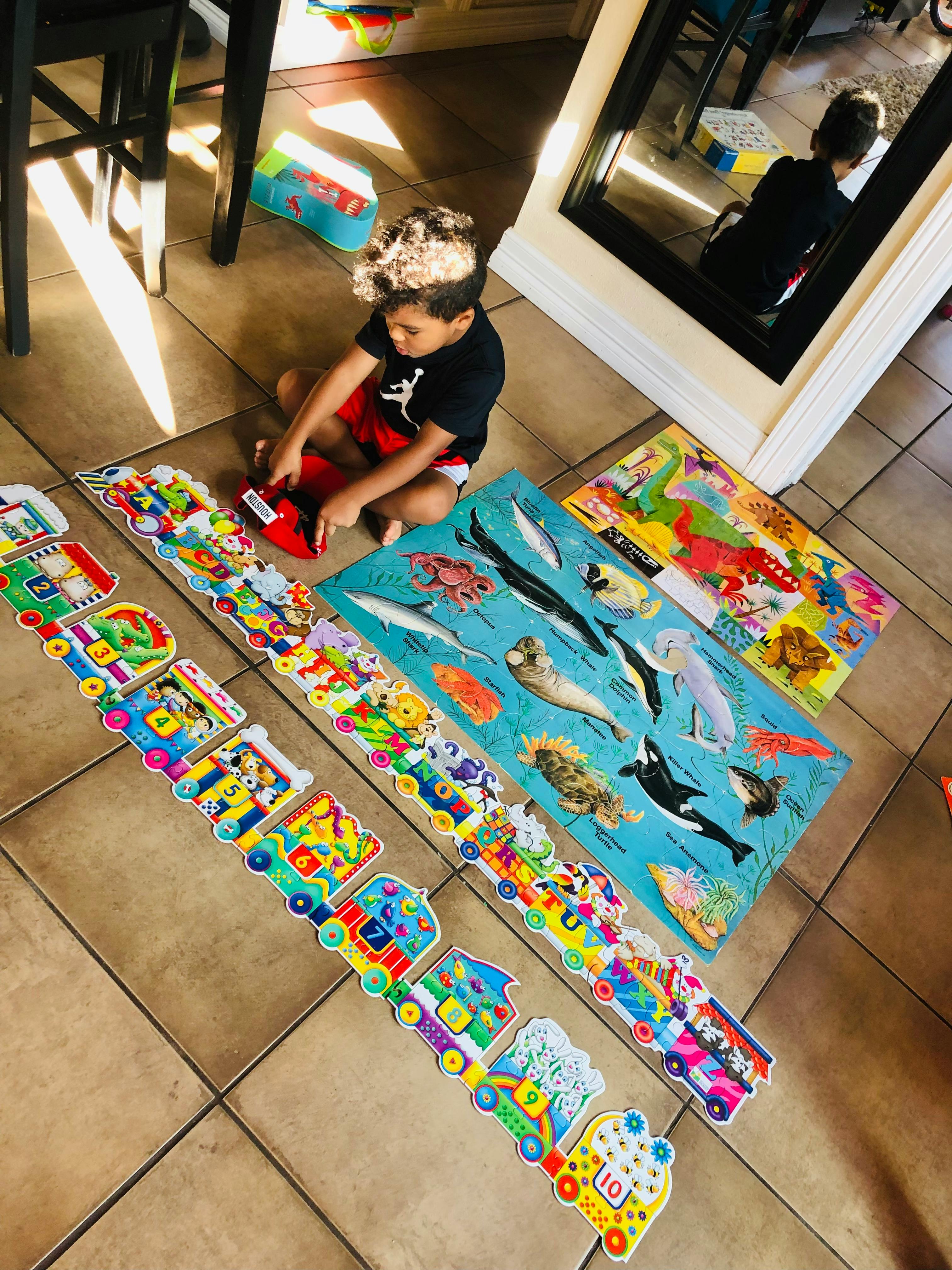 Child playing with puzzles on the floor