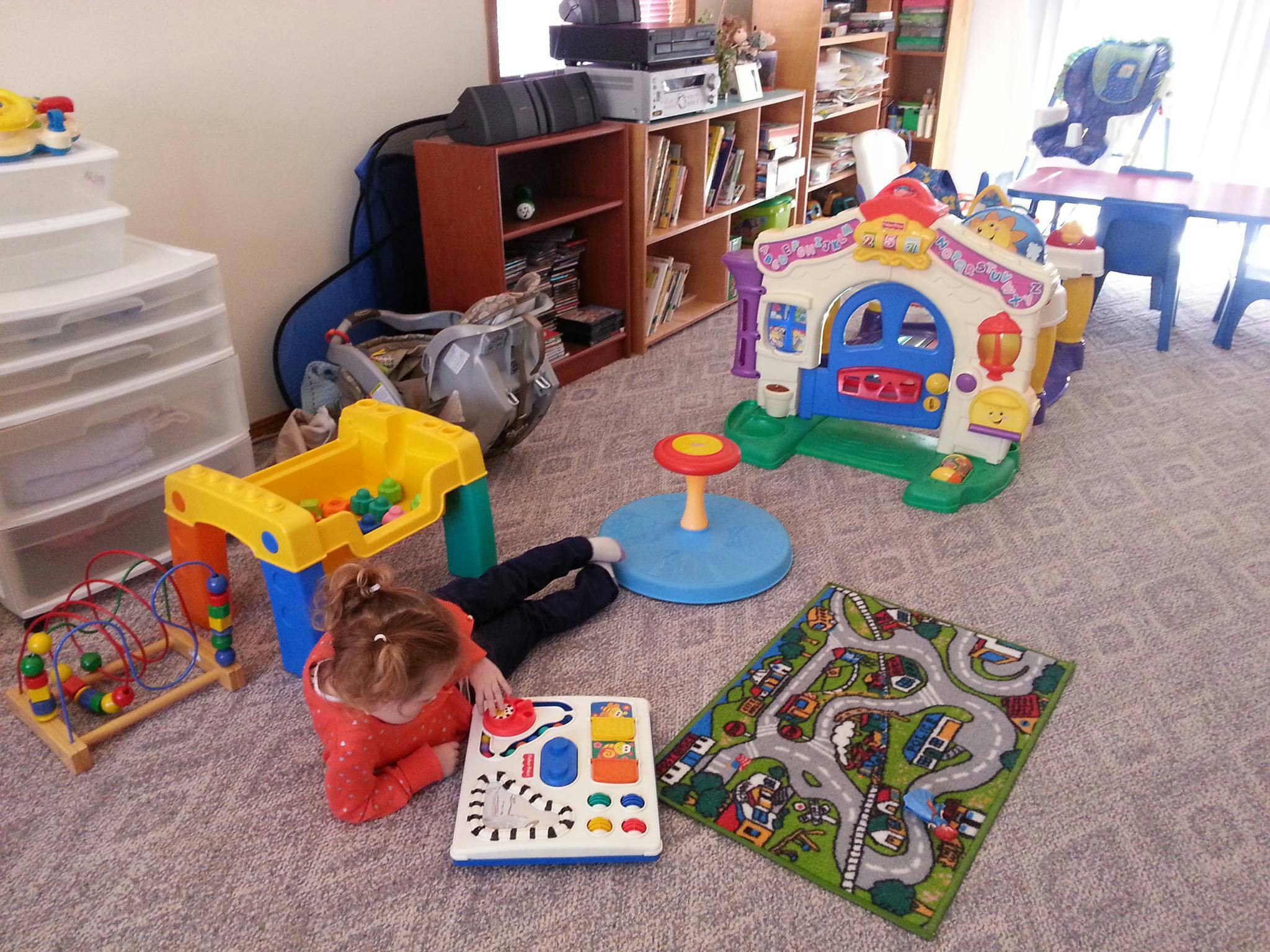 Child playing with toys on a carpeted floor