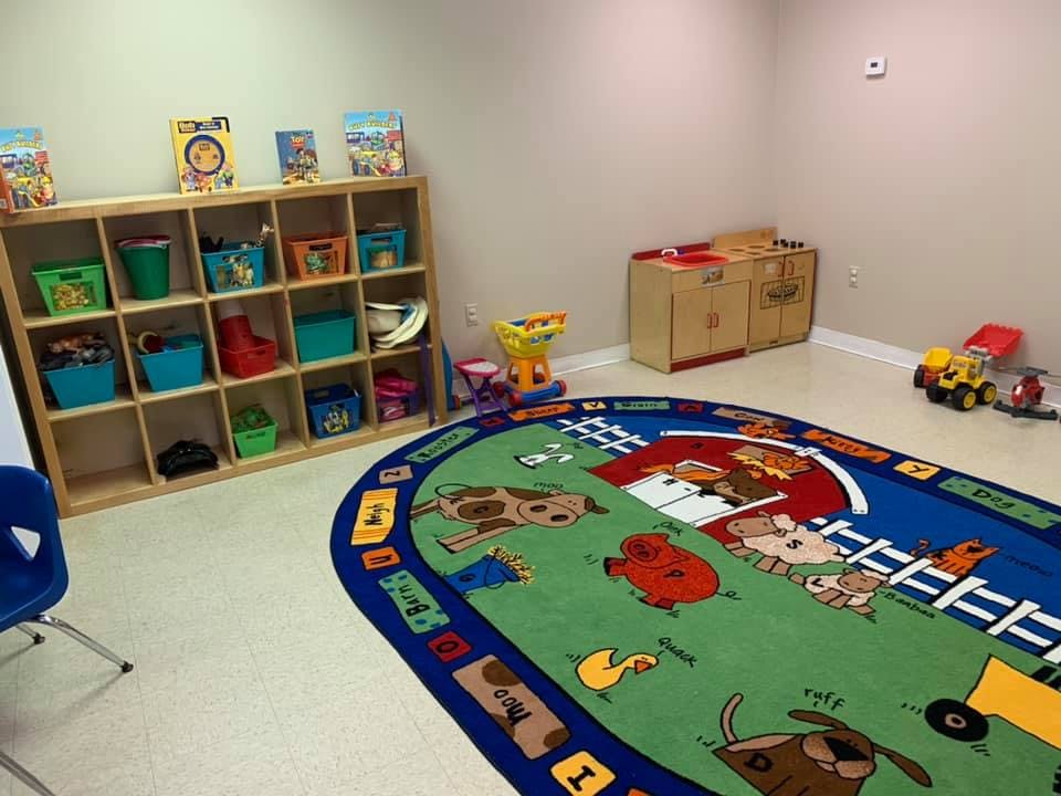 Playroom with a cubby shelf and a farm-themed rug
