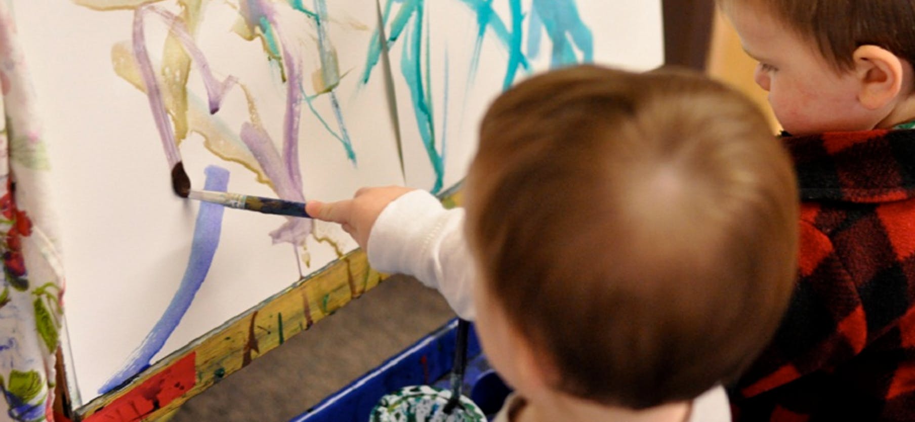 Child painting on an easel