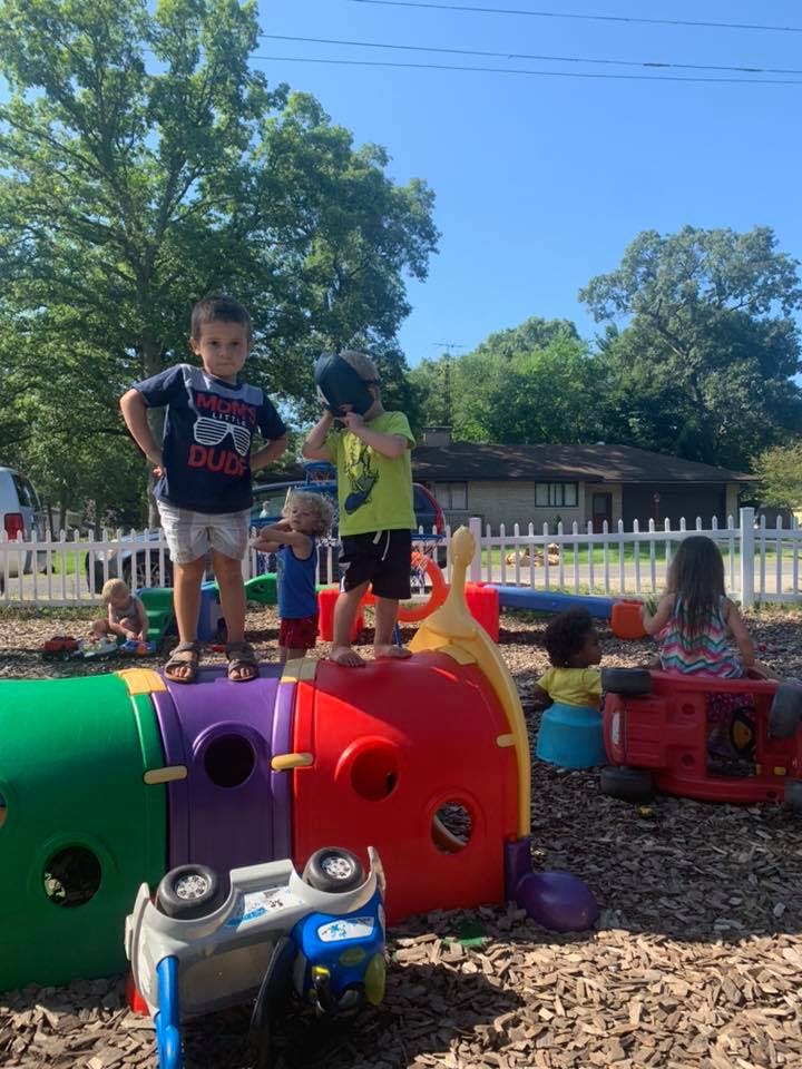 Children playing on a colorful outdoor play structure