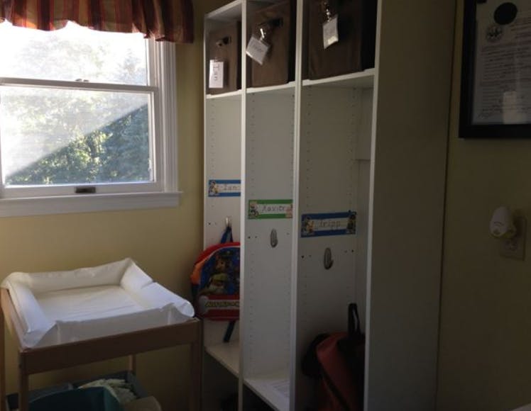 Changing table next to a window and white storage lockers