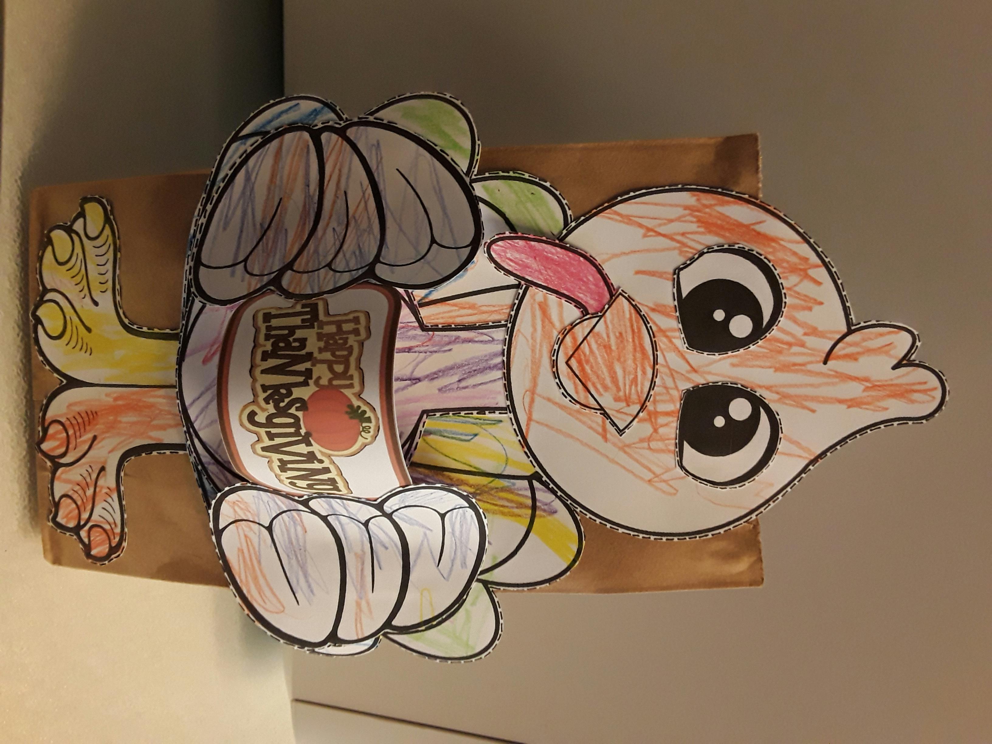 Child's drawing of a turkey with "Happy Thanksgiving" on its body