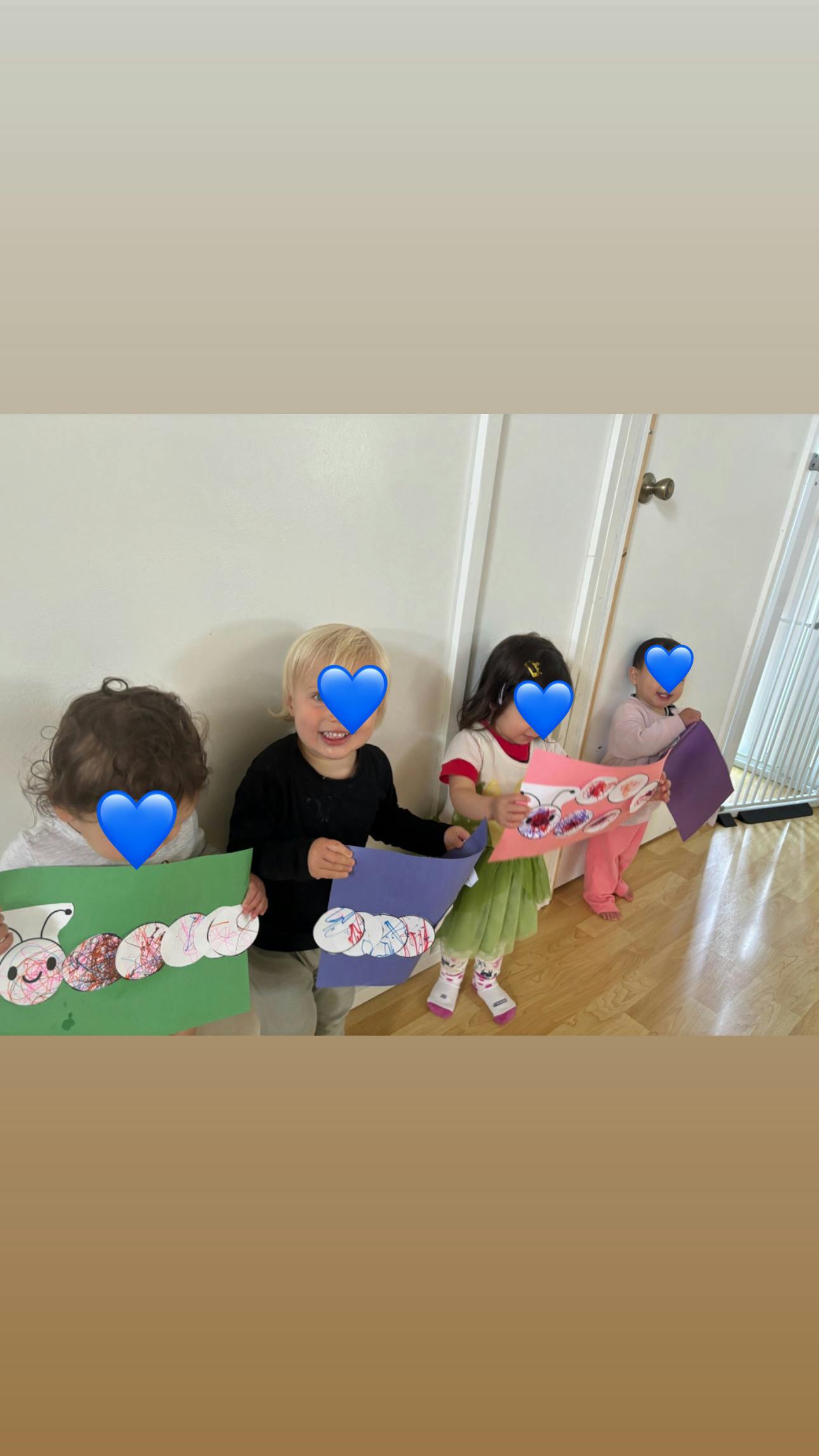 Four children holding up their paper crafts
