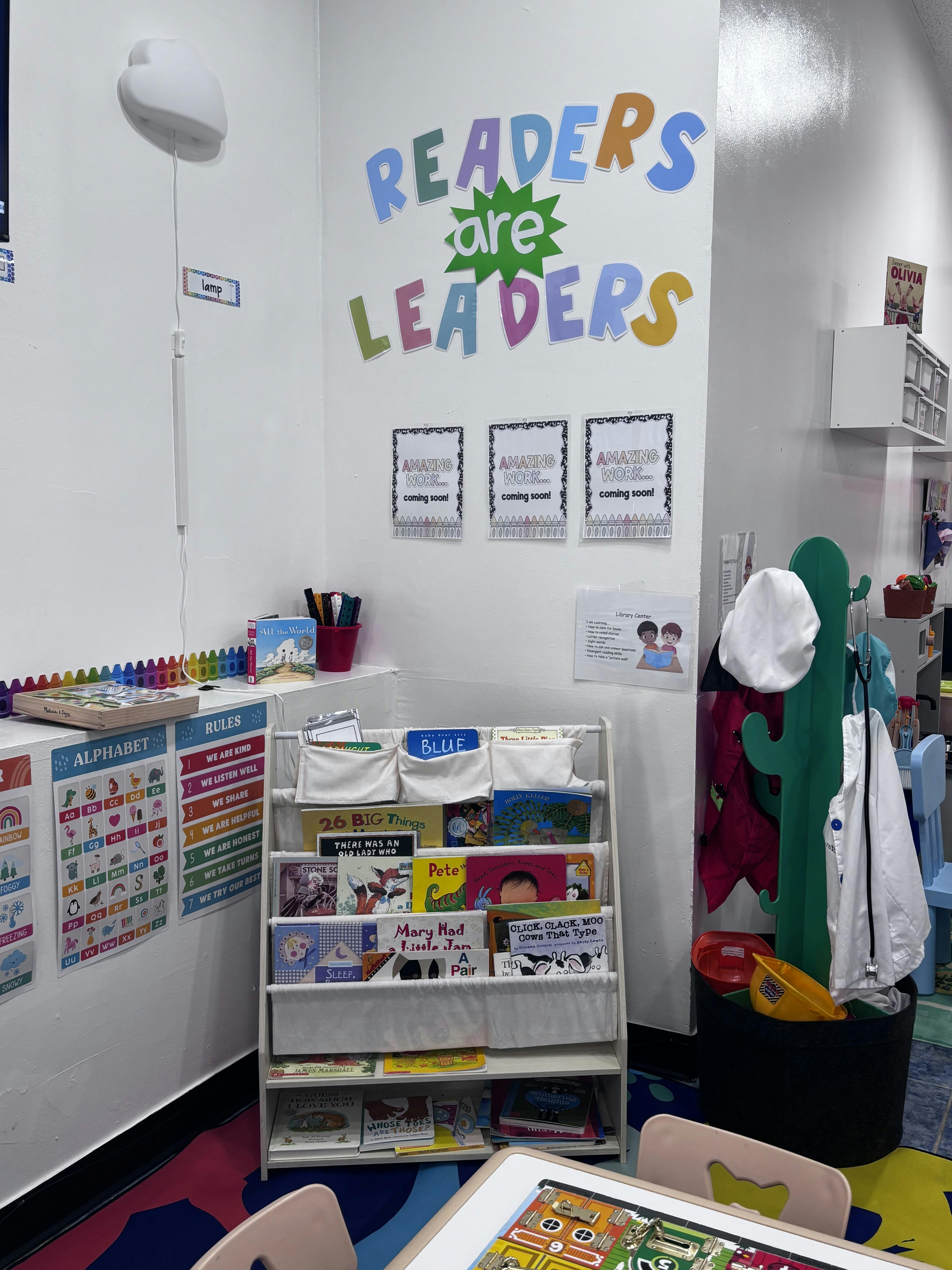 Books displayed on a classroom bookshelf under a sign reading Readers Are Leaders