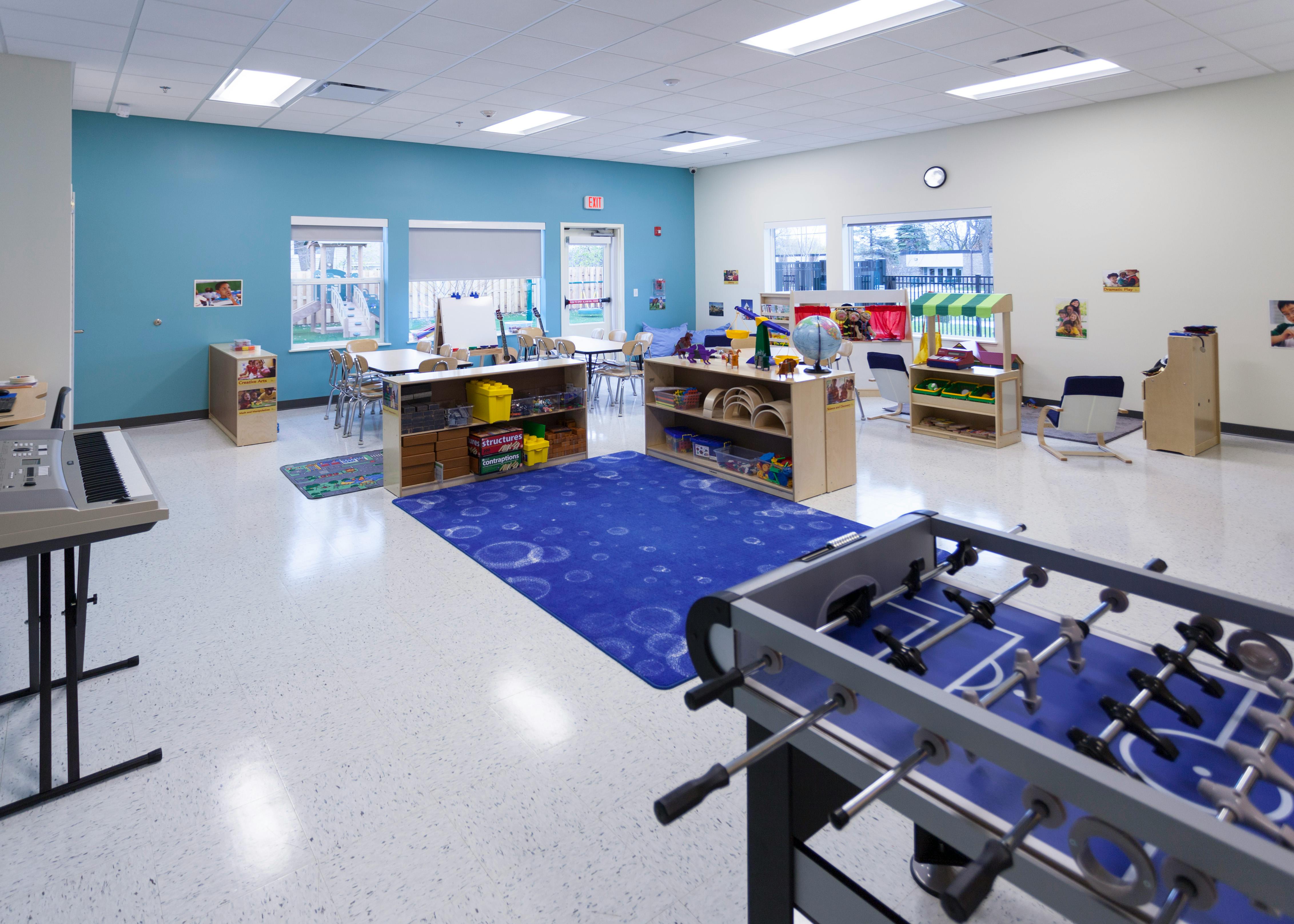 Foosball table and blue rug in a classroom