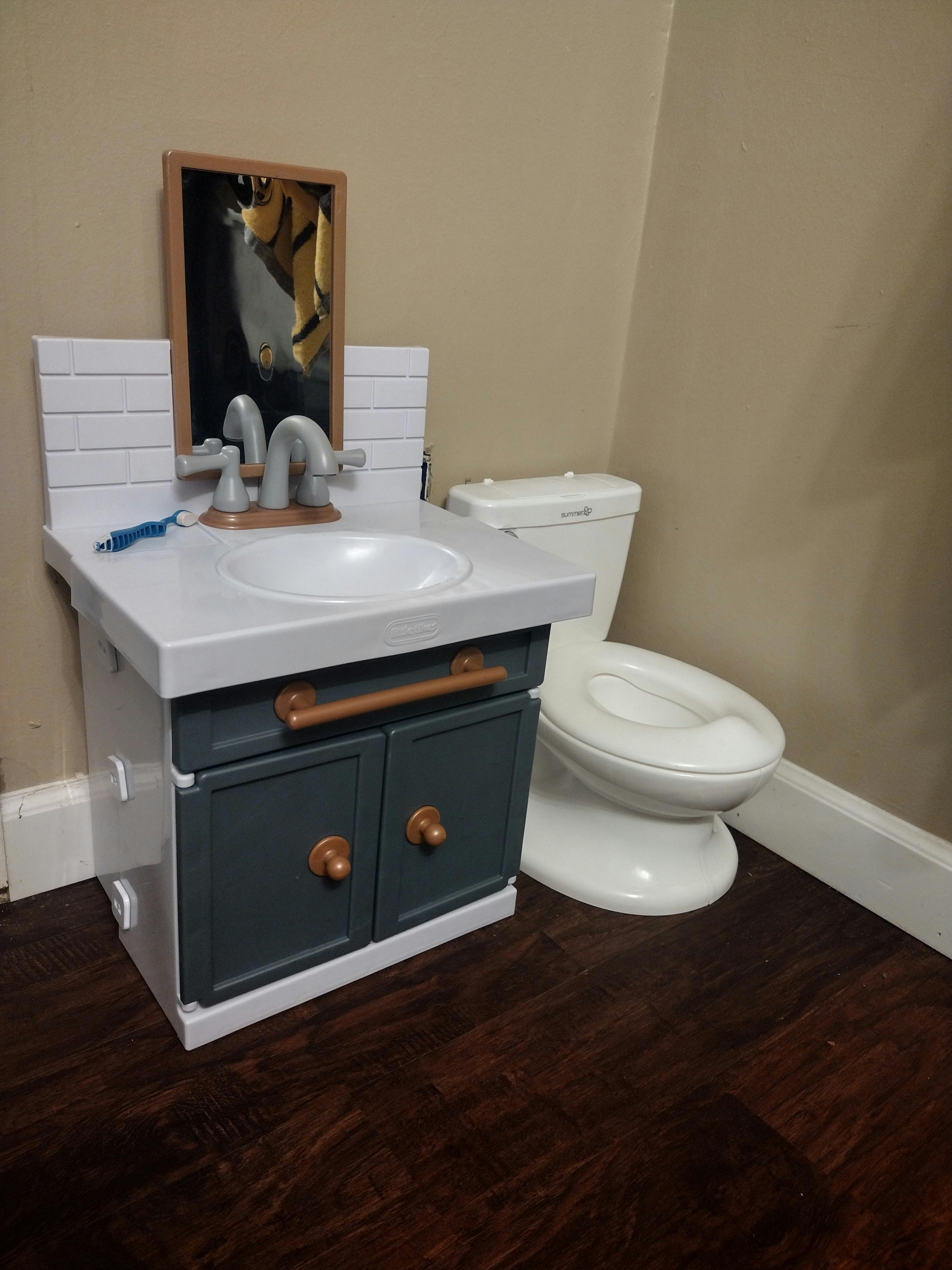 Dollhouse bathroom set with a sink vanity and a toilet