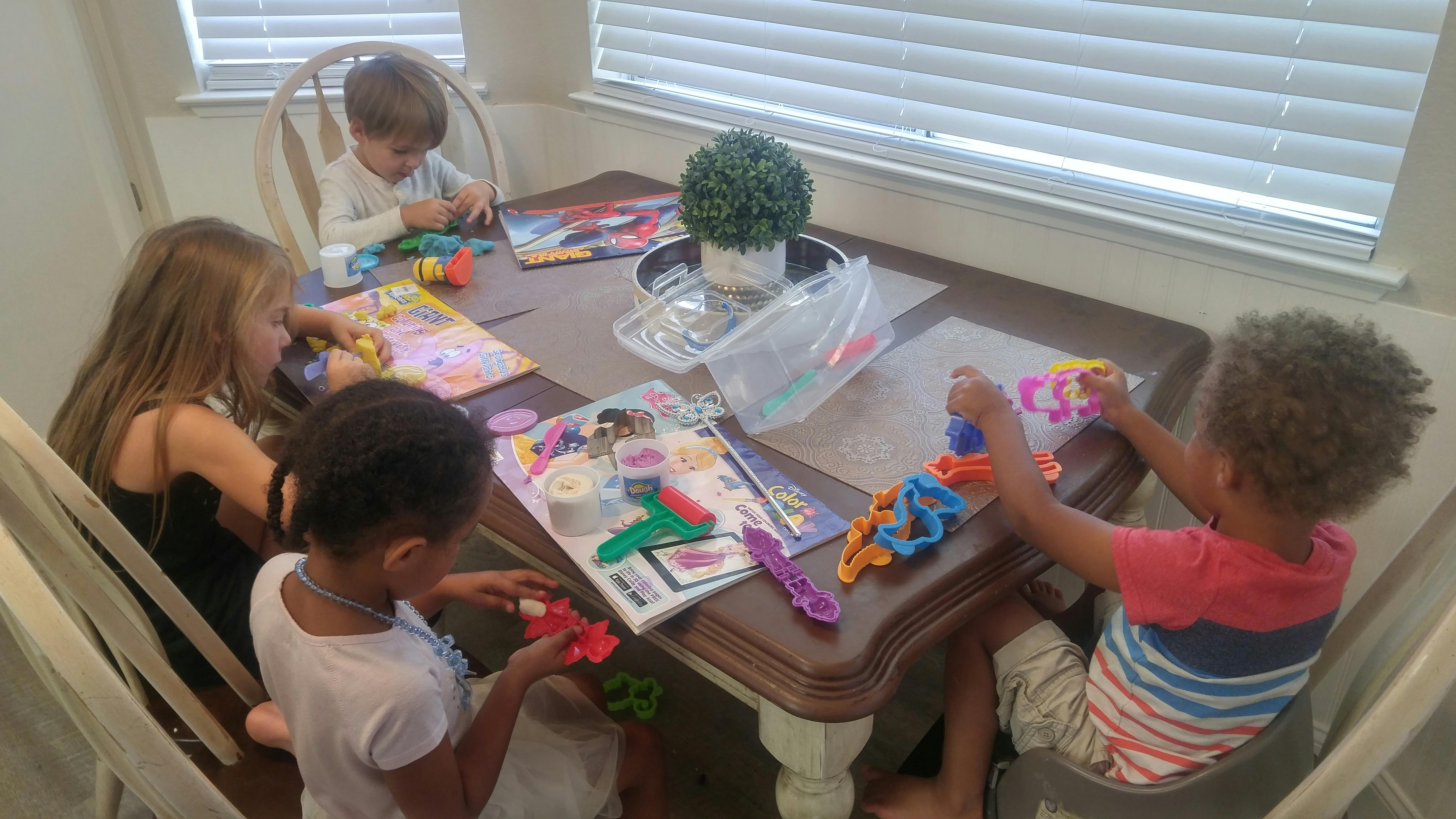Children playing with toys at a table