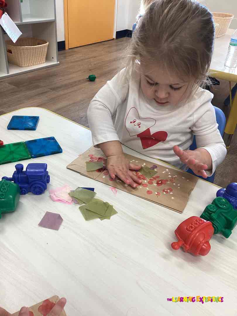 Child crafting with paper squares