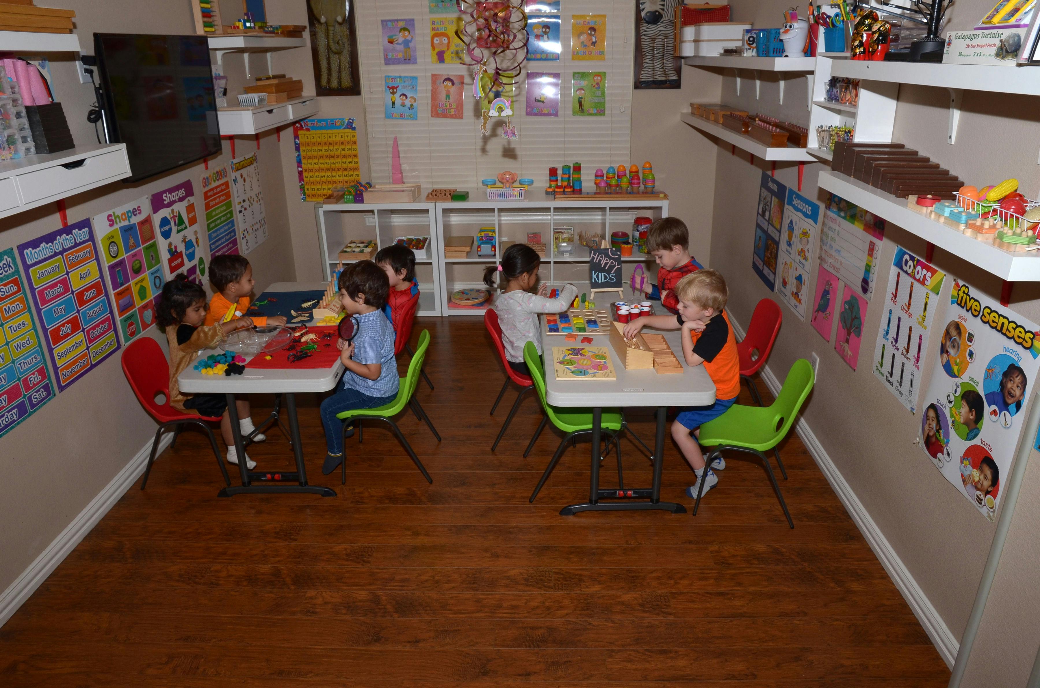 Children sitting at tables in a classroom