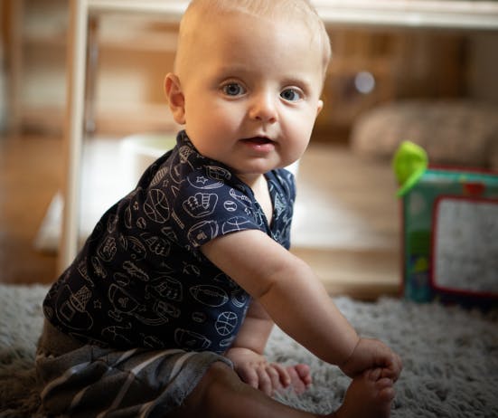 Child sitting on a rug