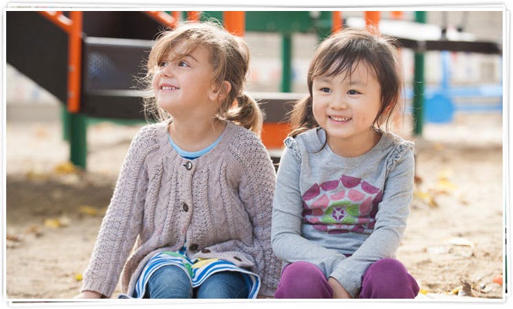 Two children sitting outdoors