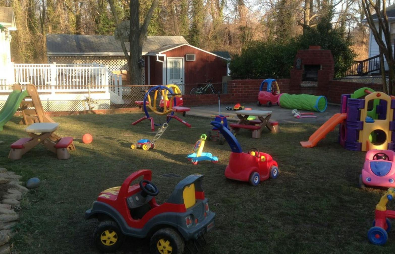 Outdoor playground with various colorful toys and play structures on grass