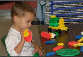Child playing with building blocks