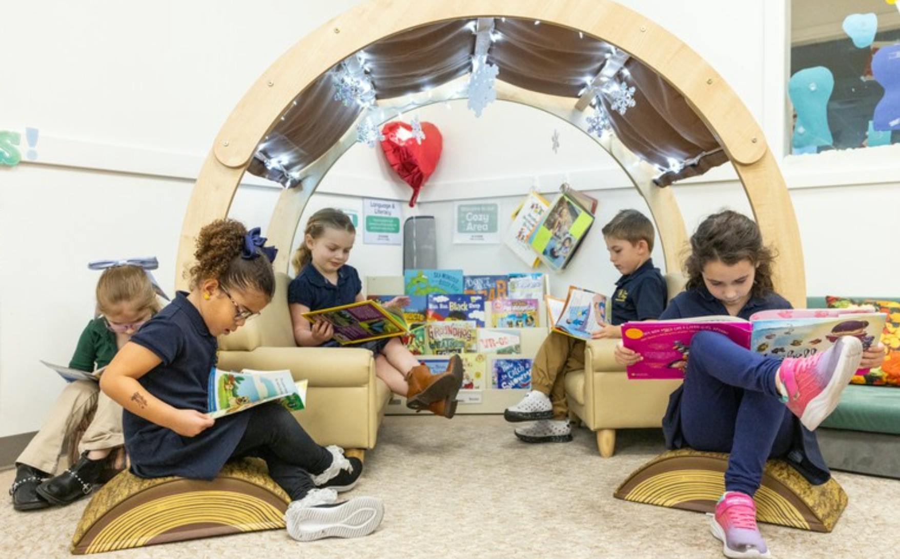 Children reading books in a cozy area