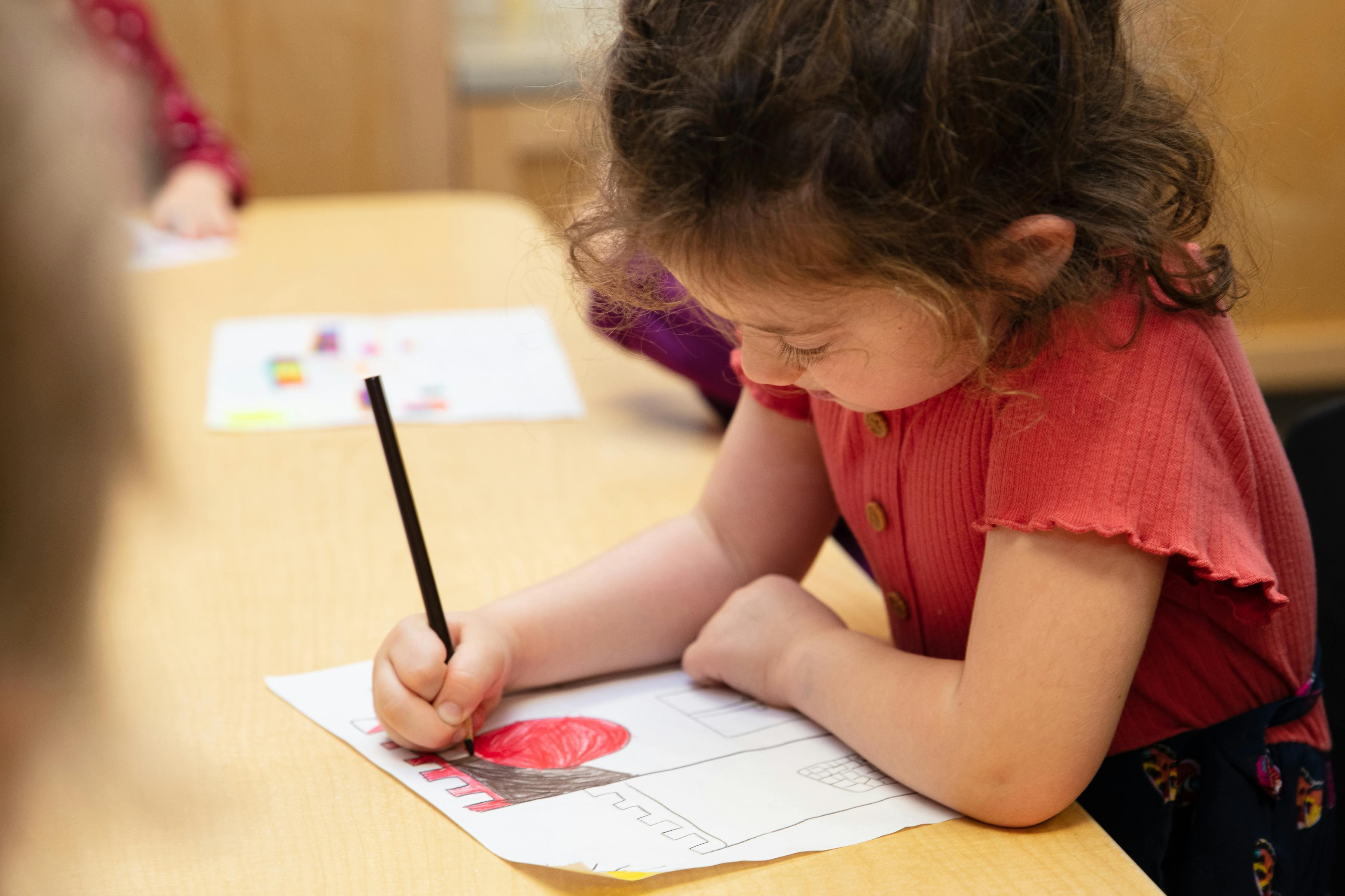 Child coloring at a table
