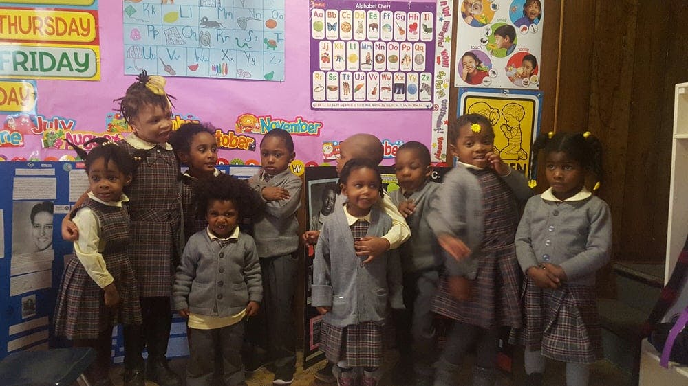 Group of children standing in a classroom