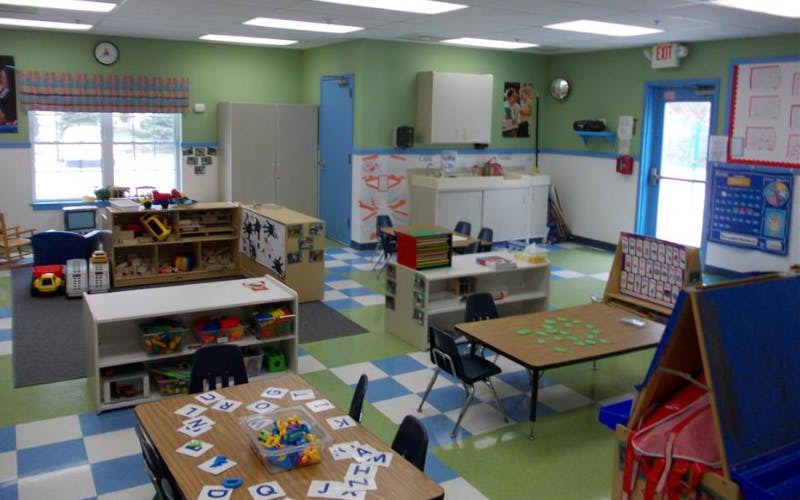 Colorful classroom with small tables, chairs, and learning materials