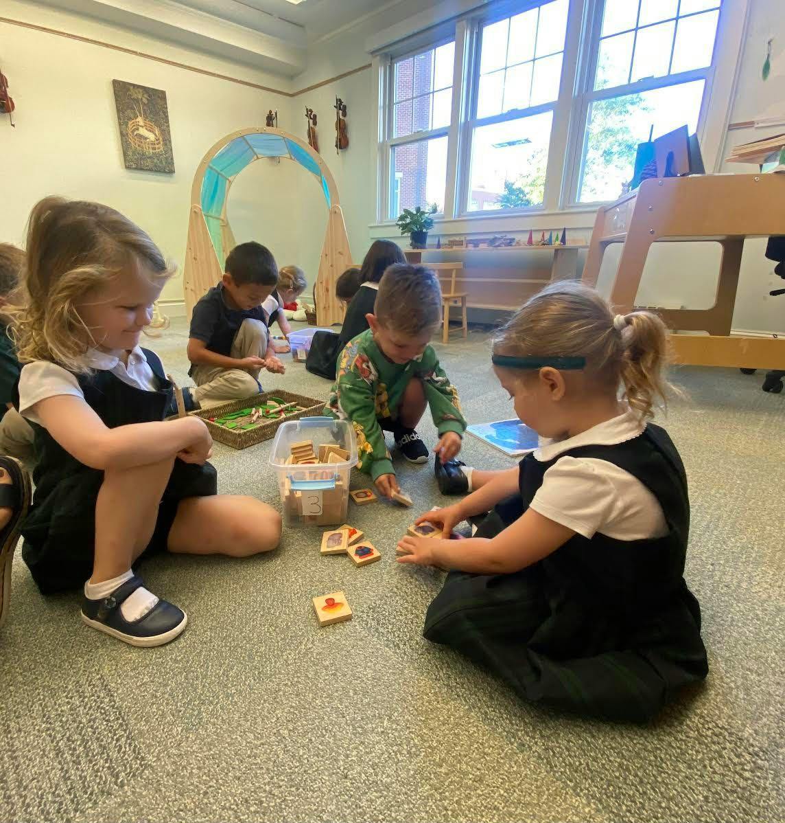 Children playing with blocks on the floor in a classroom