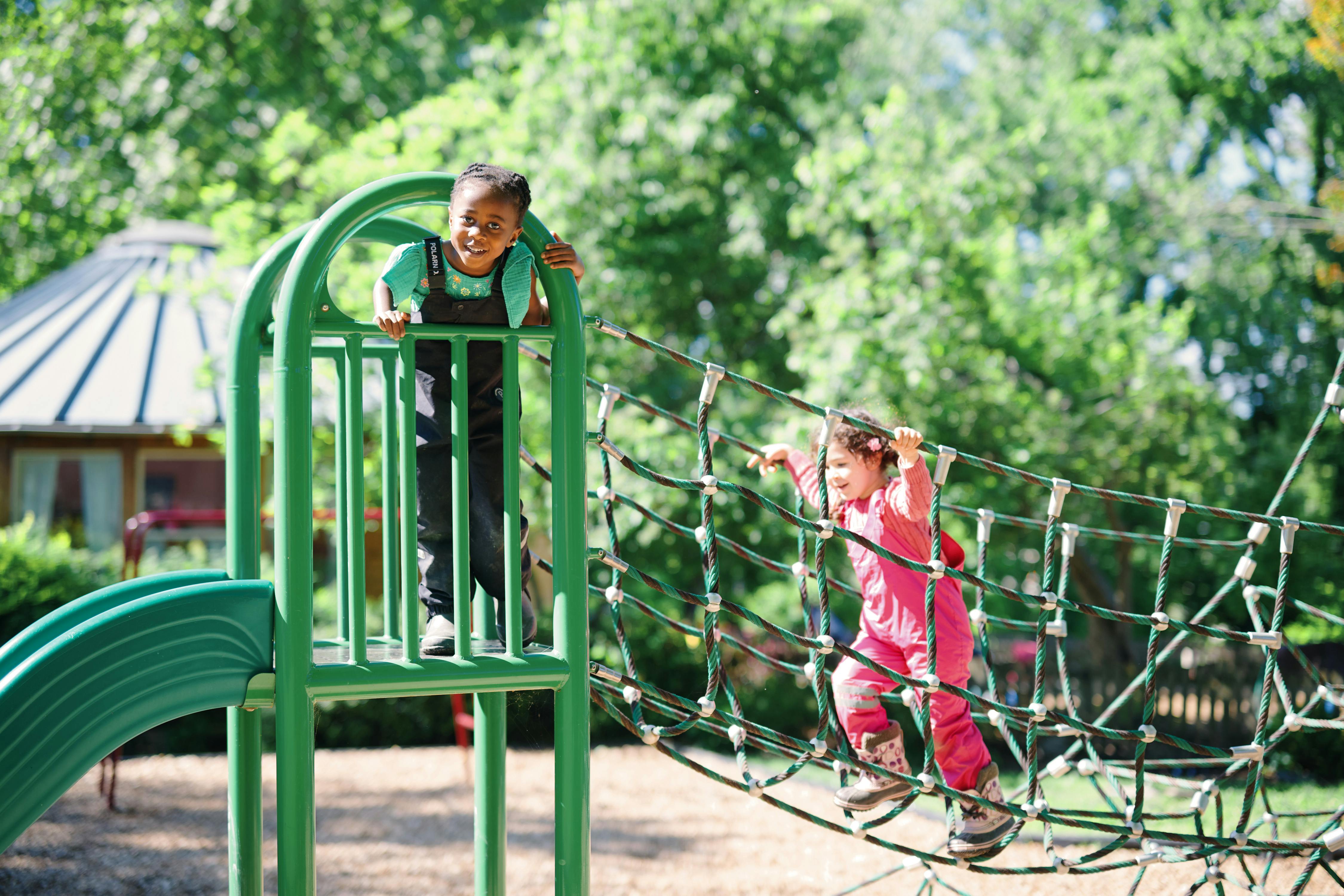 Two children playing on playground equipment
