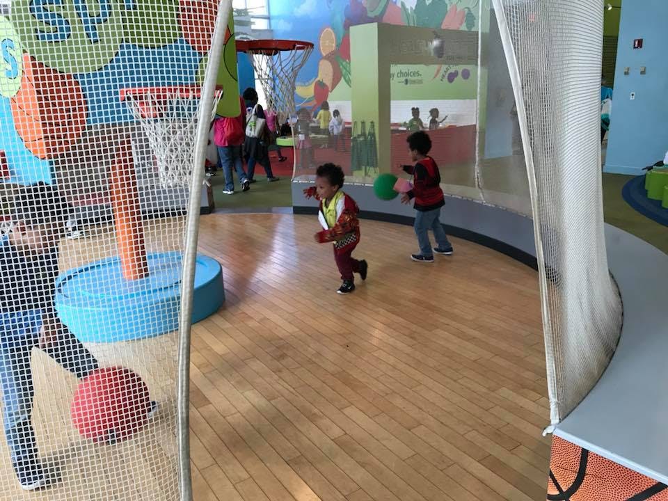 Two children playing with balls in an indoor play area