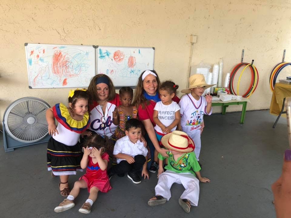 Two adults and multiple children posing for a photo