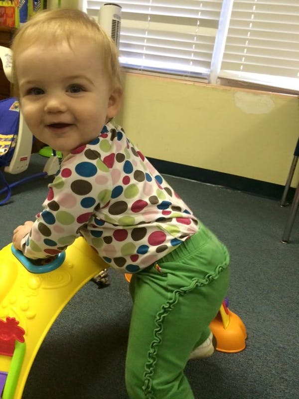 Child playing with a yellow toy