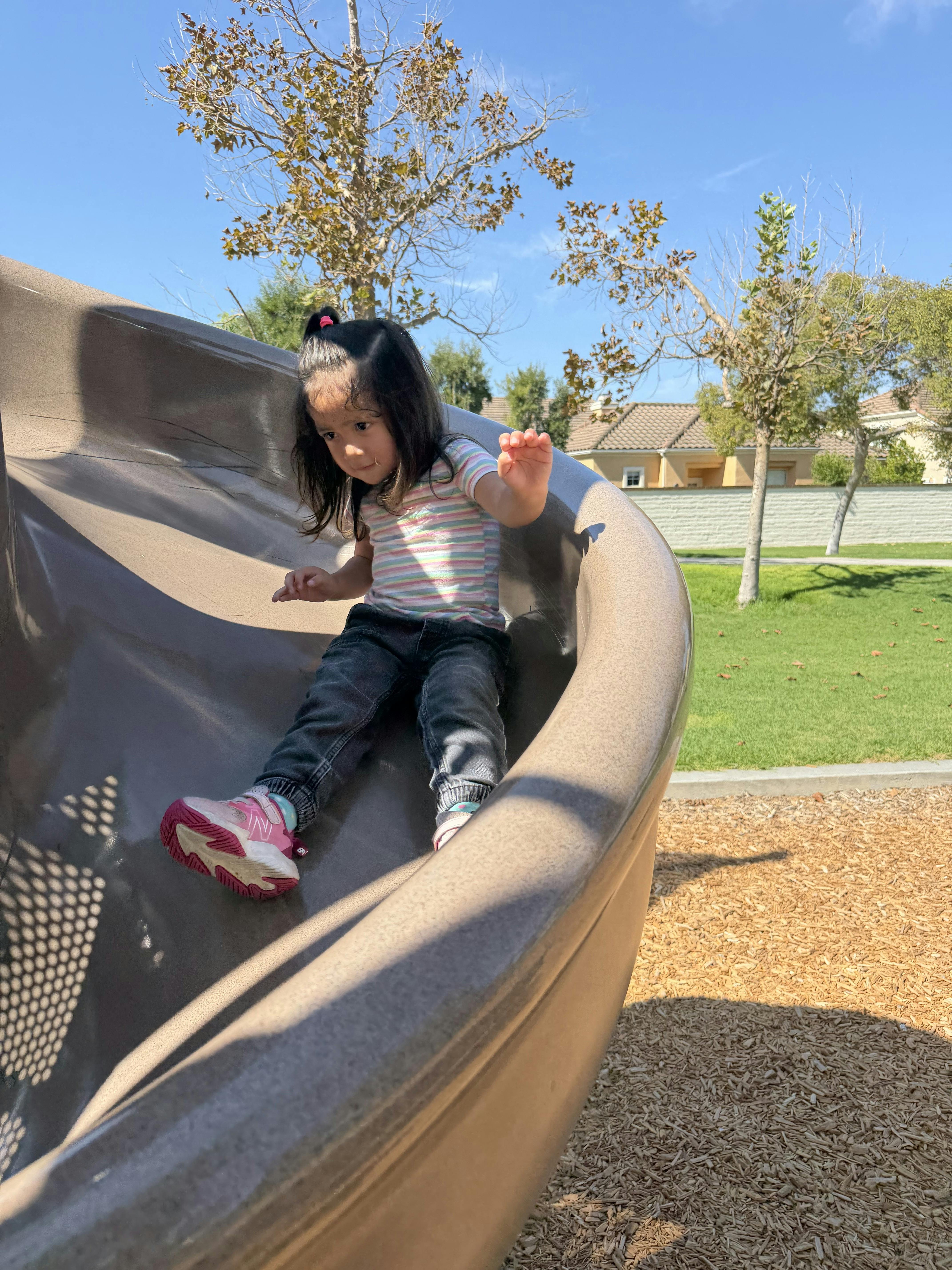 Child going down a playground slide