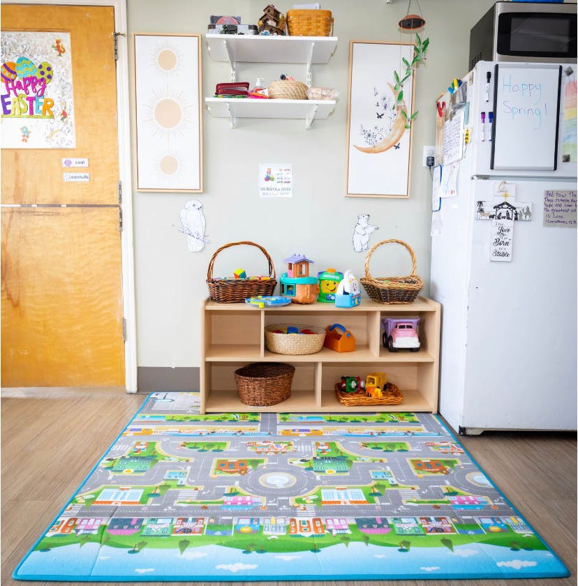 Playroom with a road map playmat, toy shelf, and refrigerator