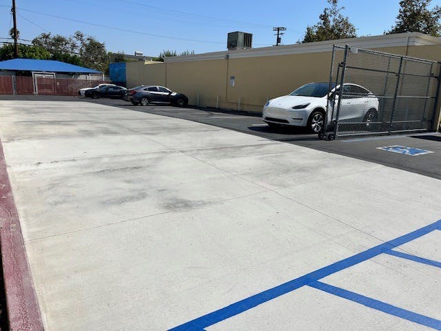 Several cars parked in a sunny parking lot
