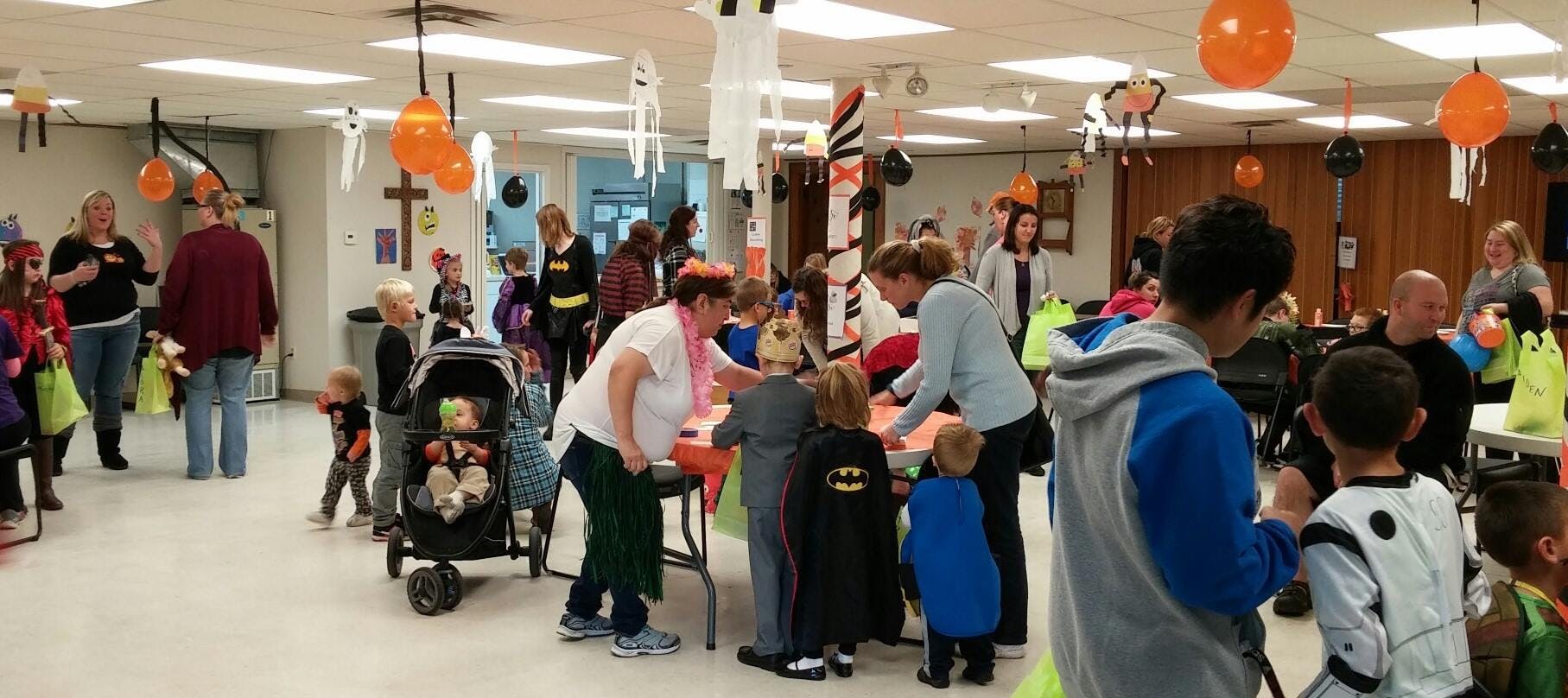 People and children gathered in a decorated room