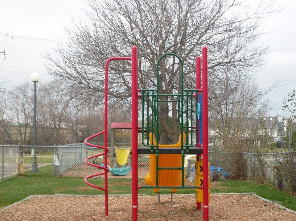 Playground structure with slides and swings