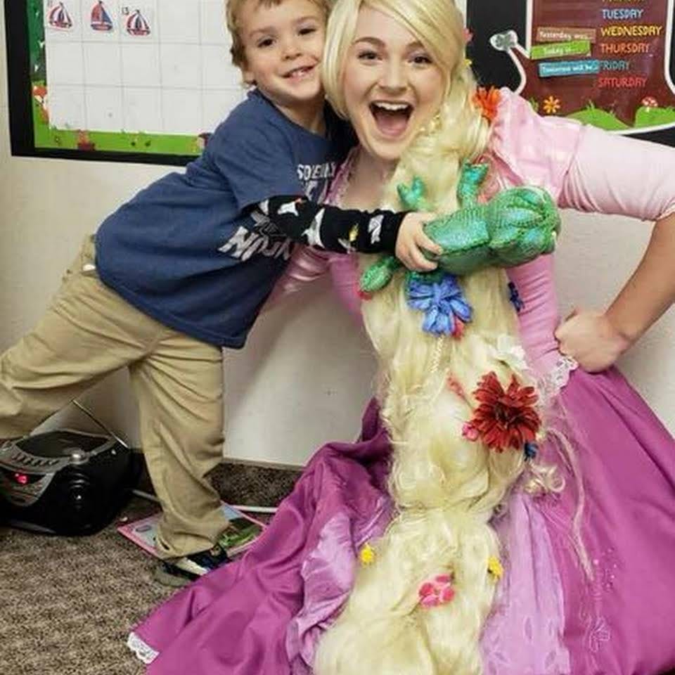 Person in costume with long blonde hair and child