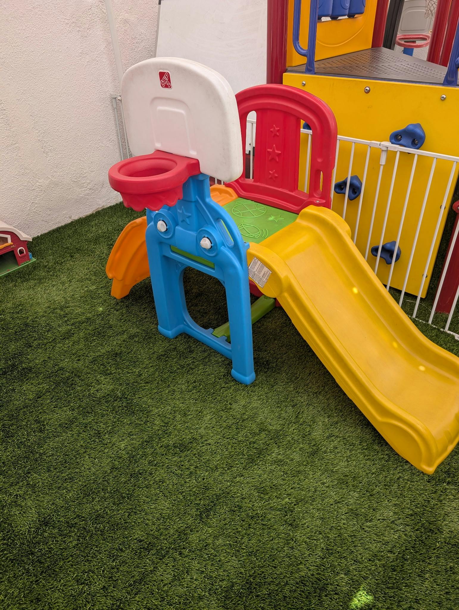 Plastic toddler playground climber with a slide and a basketball hoop