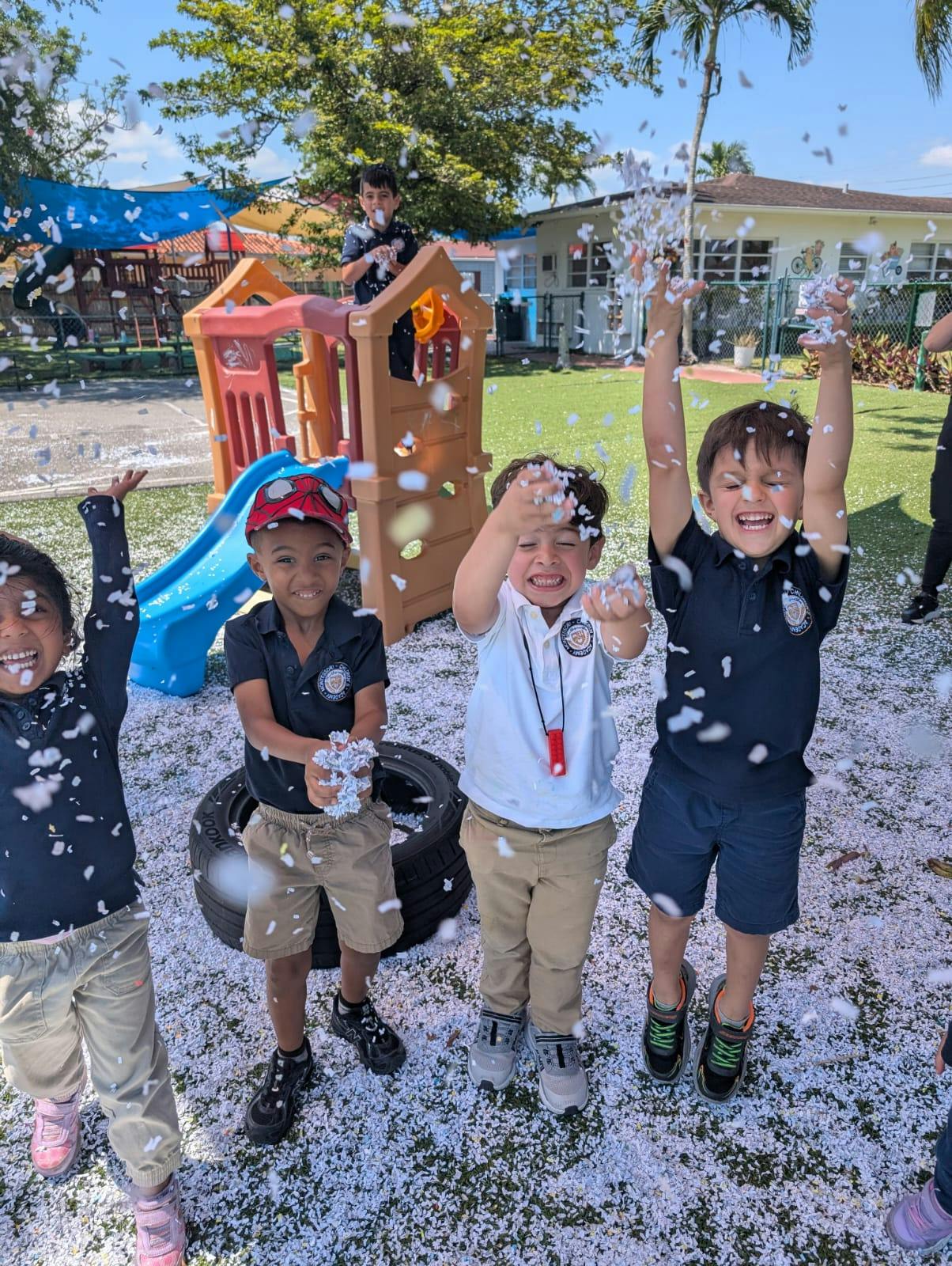Group of children throwing confetti on a playground