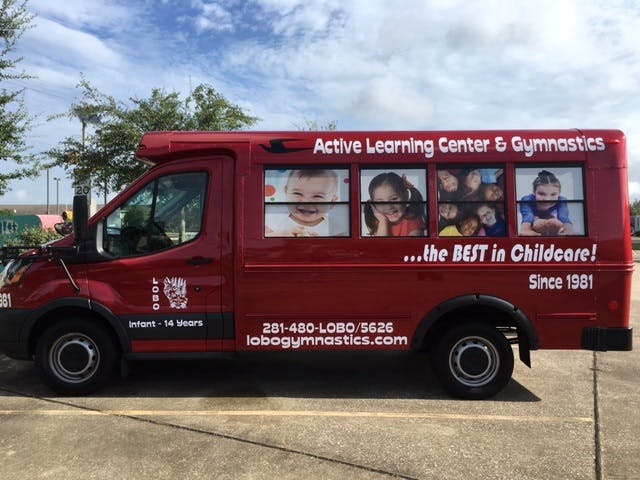 Red bus with "Active Learning Center & Gymnastics" and images of children