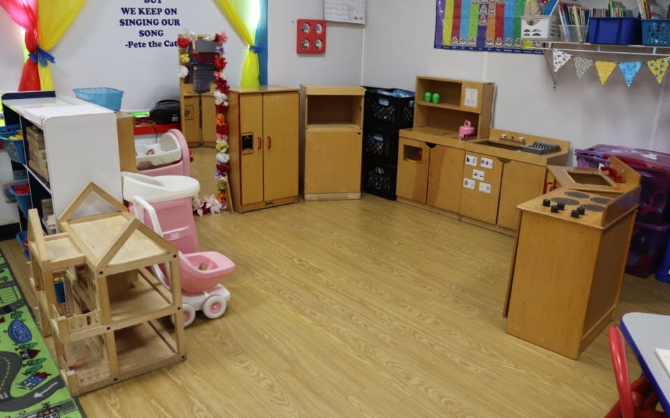 Empty classroom with wooden play furniture and toys