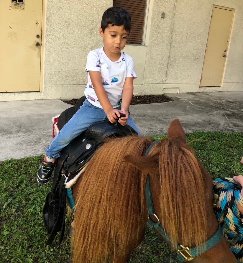 Child riding a horse