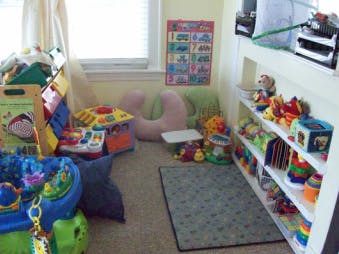 Playroom with toys, shelves, and a window