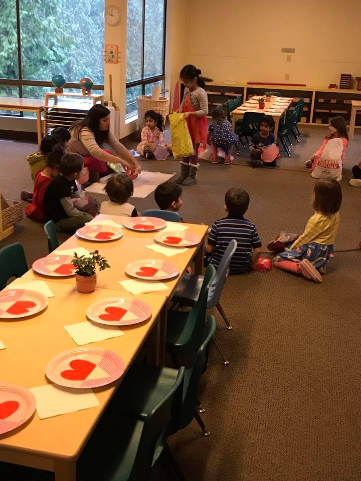 Adult and children sitting on floor in a classroom