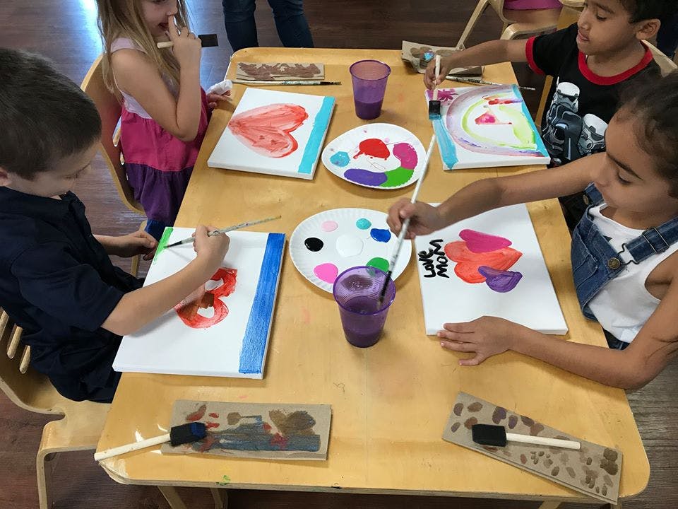 Children painting at a table