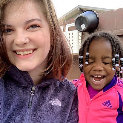 Smiling person next to a laughing child