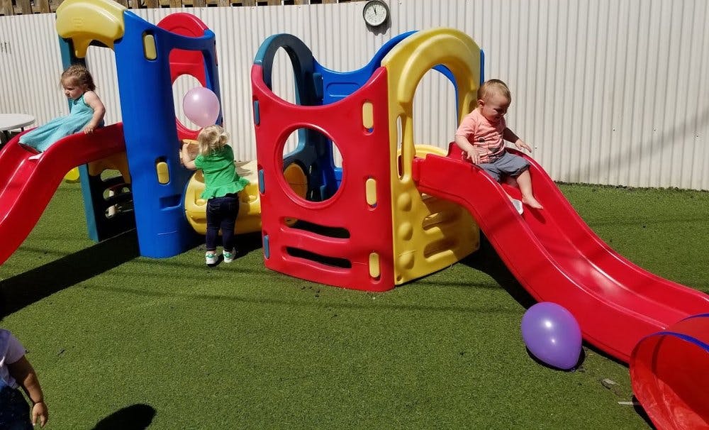 Children playing on a playground slide