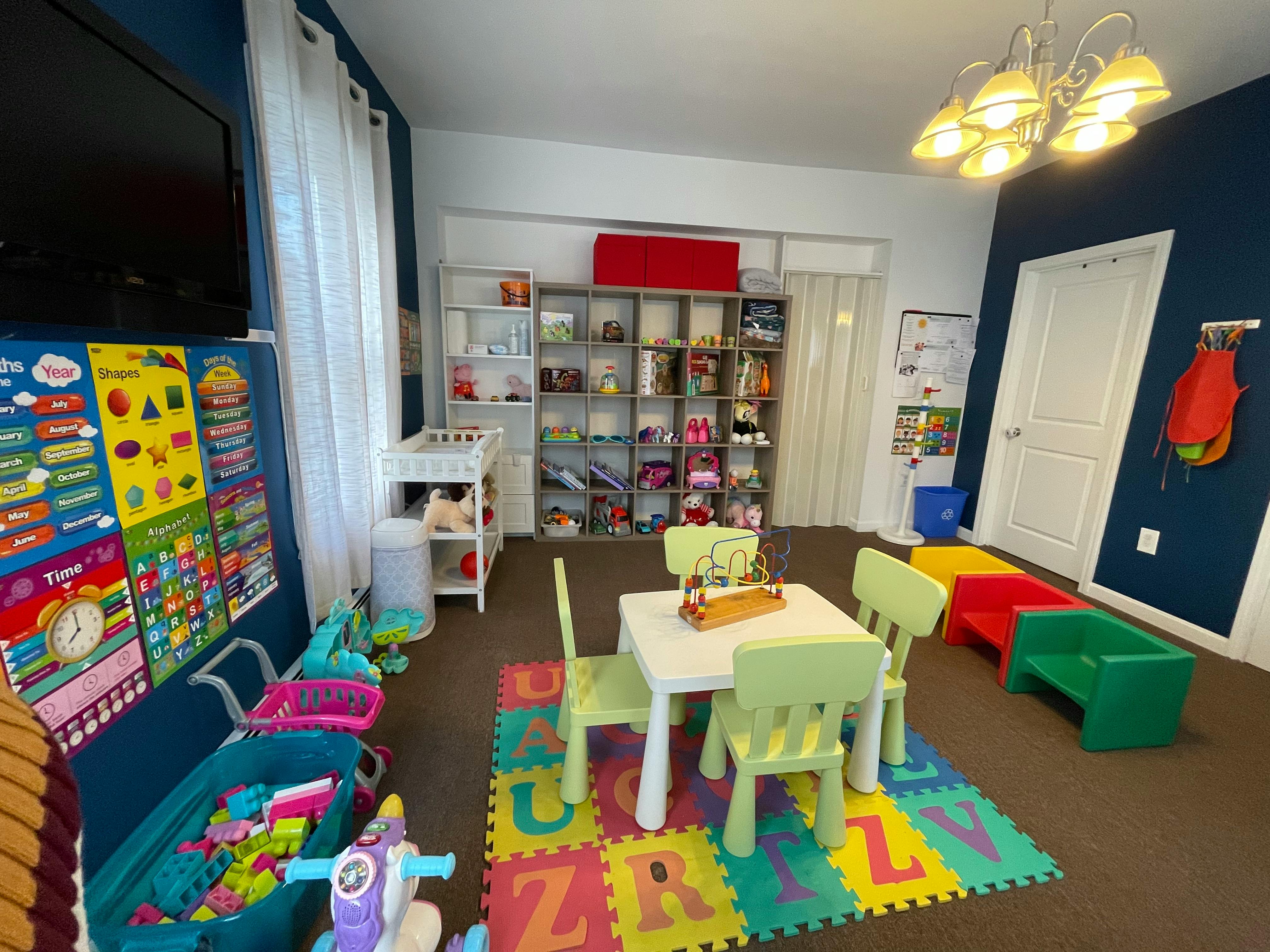 Playroom with small table and chairs on an alphabet mat
