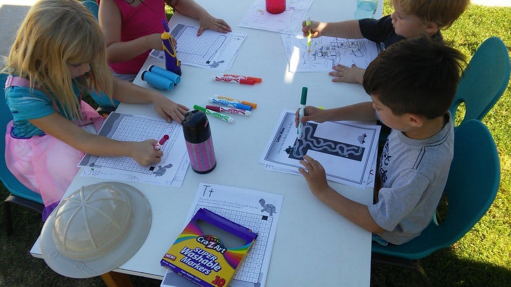 Children drawing and coloring at a table