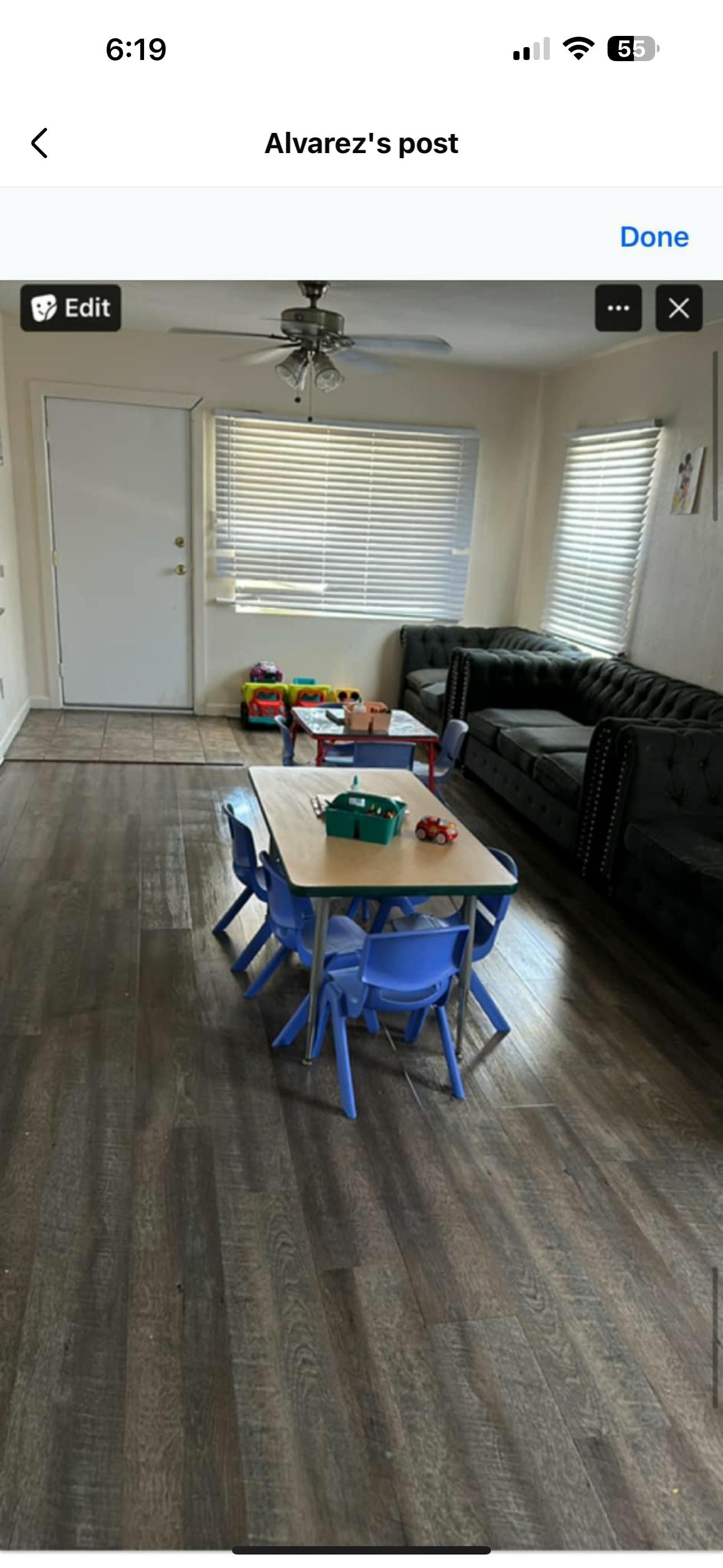 Living room with a dark gray sectional sofa and two child-sized tables with chairs