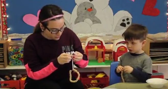 Person and child making crafts