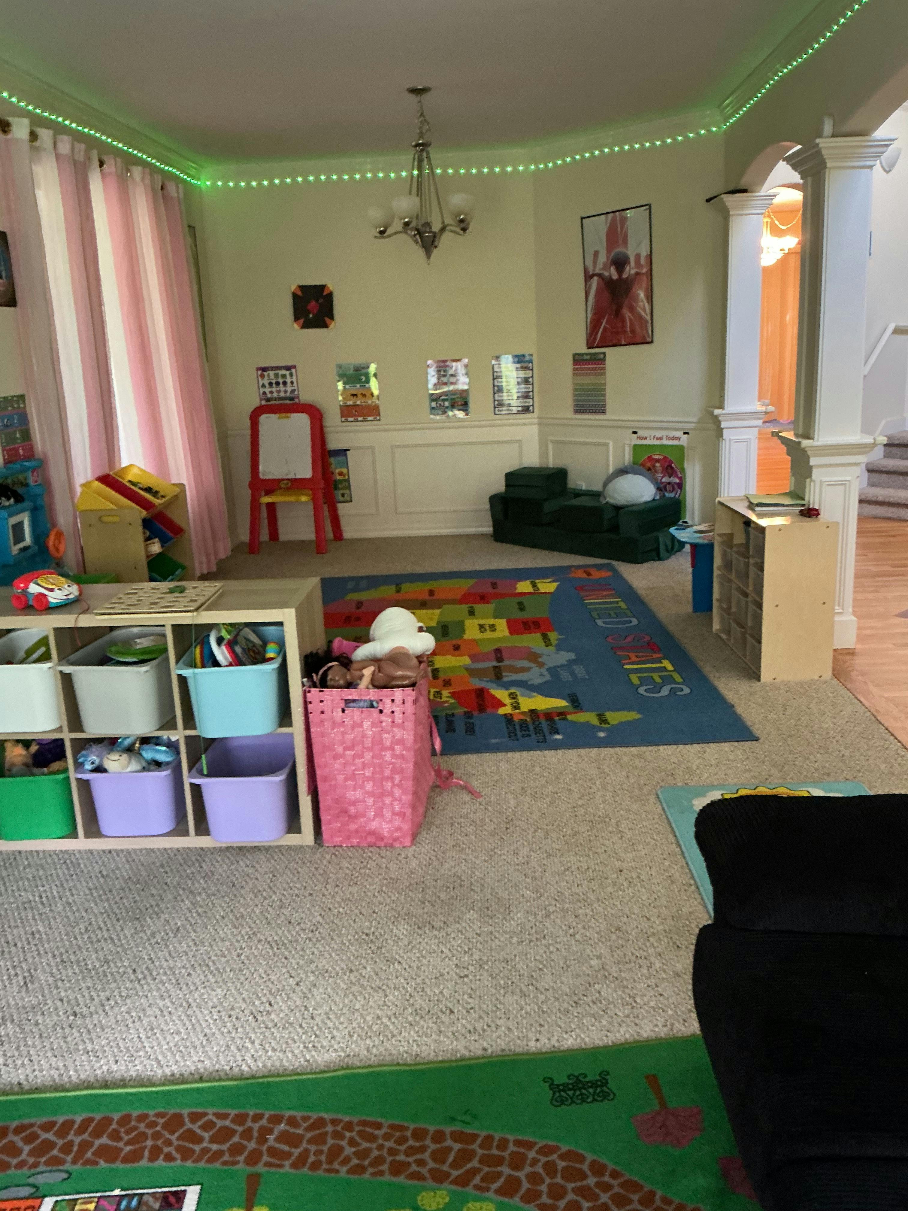 Playroom with storage units, a map rug, and educational wall posters