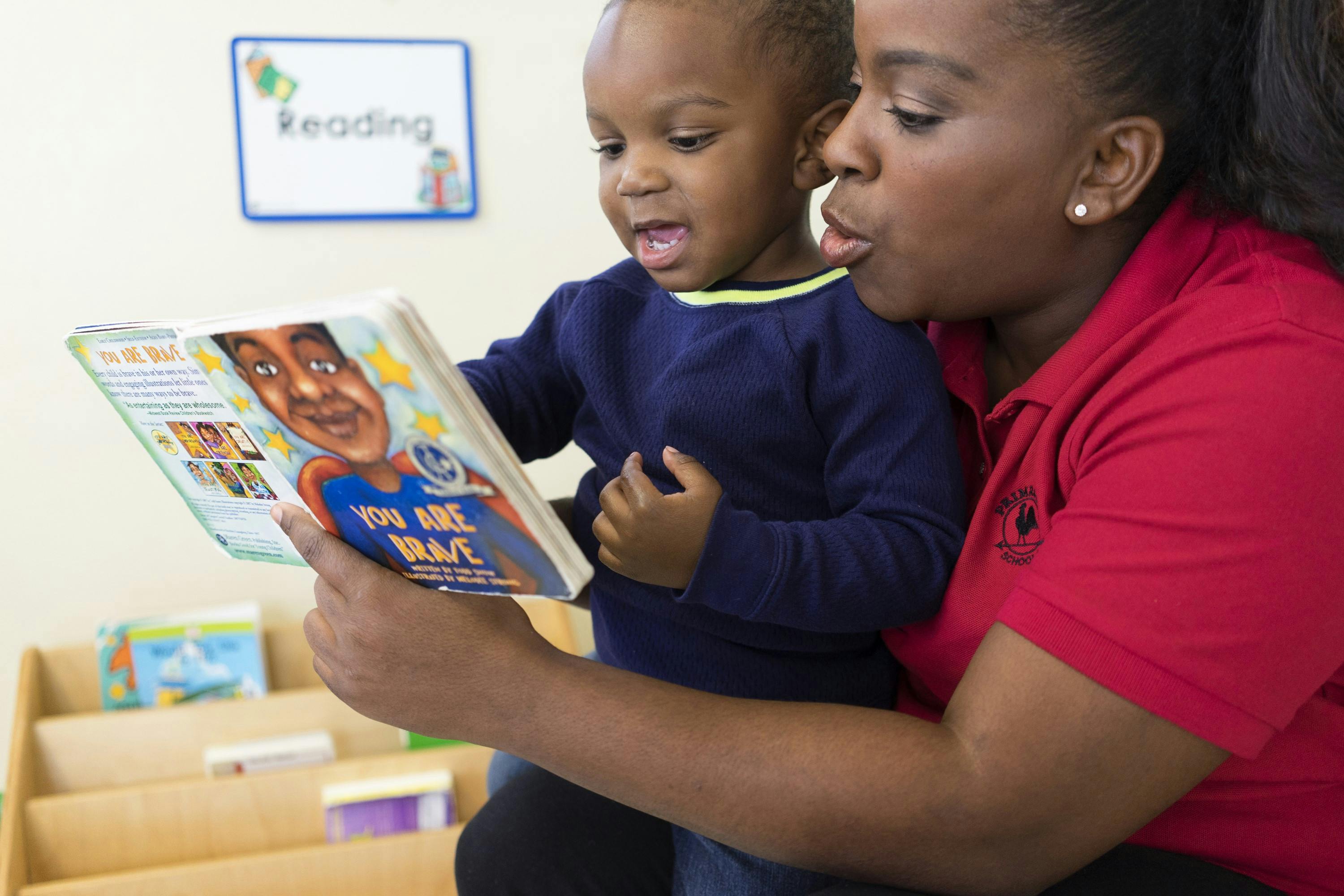 Adult reading a book to a child