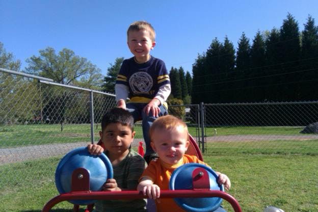 Three children on playground equipment